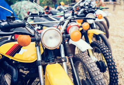 Close-up of motorcycles parked outdoors