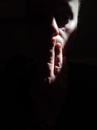 Close-up portrait of man in darkroom