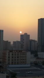 Cityscape against clear sky during sunset