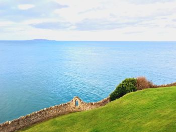 Scenic view of sea against cloudy sky