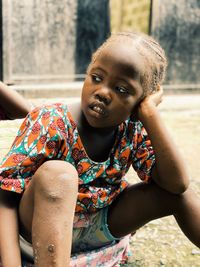 Portrait of a girl sitting outdoors