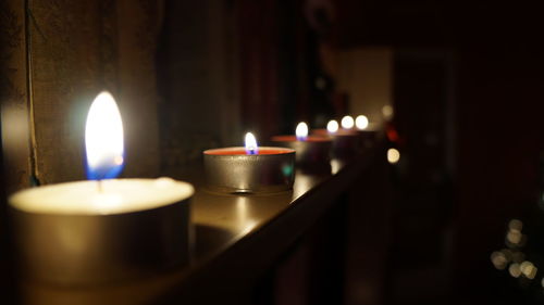 Tea light candles burning in room