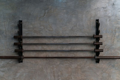 Rack with barbells on wall in gym