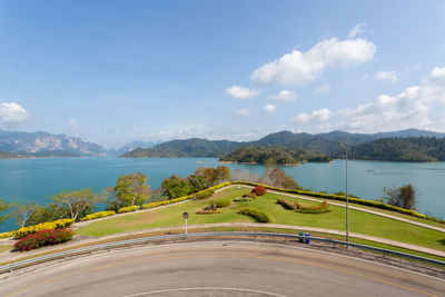 Scenic view of lake by mountains against sky