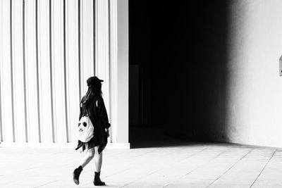 Rear view full length of woman entering building