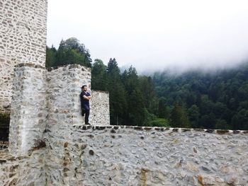 Full length of man standing against wall