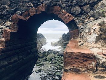 Scenic view of sea seen through arch