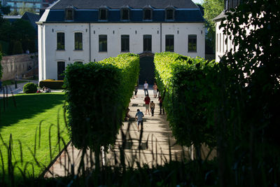 People in garden by building