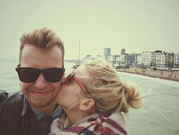 Woman kissing man at beach