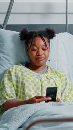 Female patient talking on video call at hospital ward