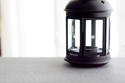 Close-up of electric lamp on table