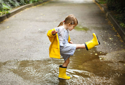 Full length of girl playing in water