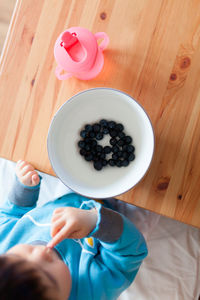 High angle view of woman holding bowl