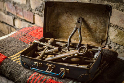 Close up of rusty work tools in suitcase at workshop