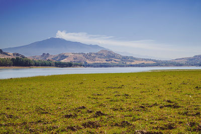 Scenic view of lake and mountains against sky