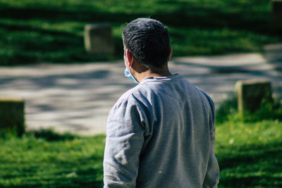 Rear view of man standing on field