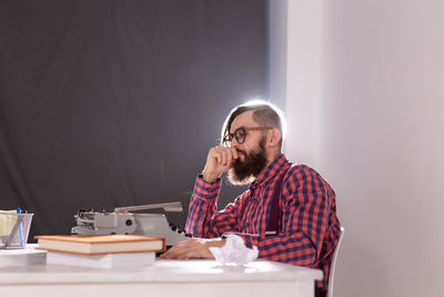 Young man sitting on table