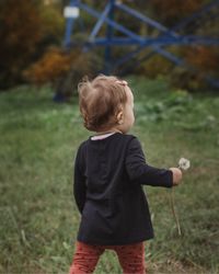 Boy standing on grass