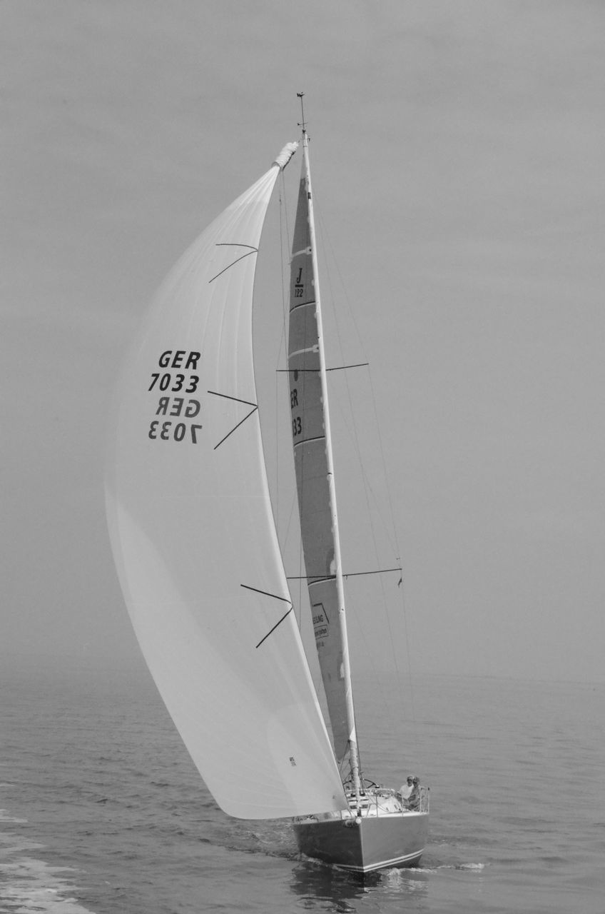 BOAT SAILING ON SEA AGAINST SKY