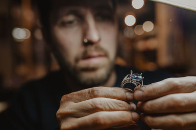 Close-up portrait of man holding hands