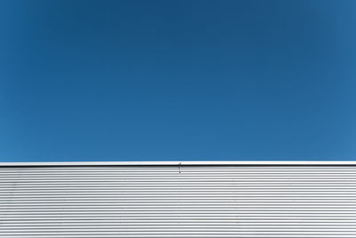 Low angle view of built structure against clear blue sky