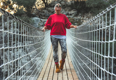Full length of man standing on footbridge