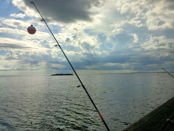 Scenic view of sea against cloudy sky