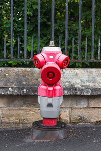 Red fire hydrant on footpath