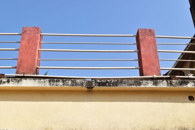 Low angle view of bridge against clear blue sky