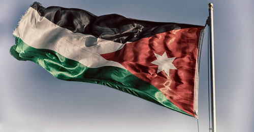 Low angle view of flag against the sky