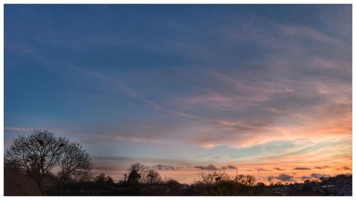 Low angle view of cloudy sky at sunset