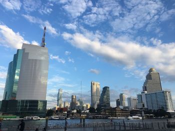 Low angle view of buildings against cloudy sky