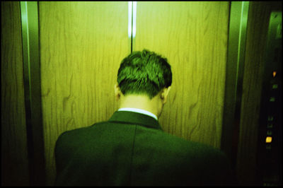 Rear view of businessman in elevator