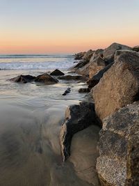 Scenic view of sea against clear sky at sunset