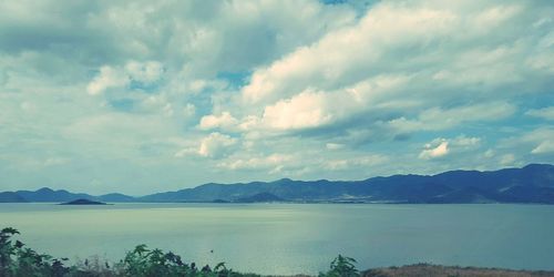 Scenic view of sea against cloudy sky