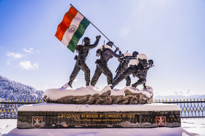 Low angle view of flag on snow covered mountain