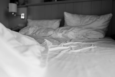 White lying on bed at home