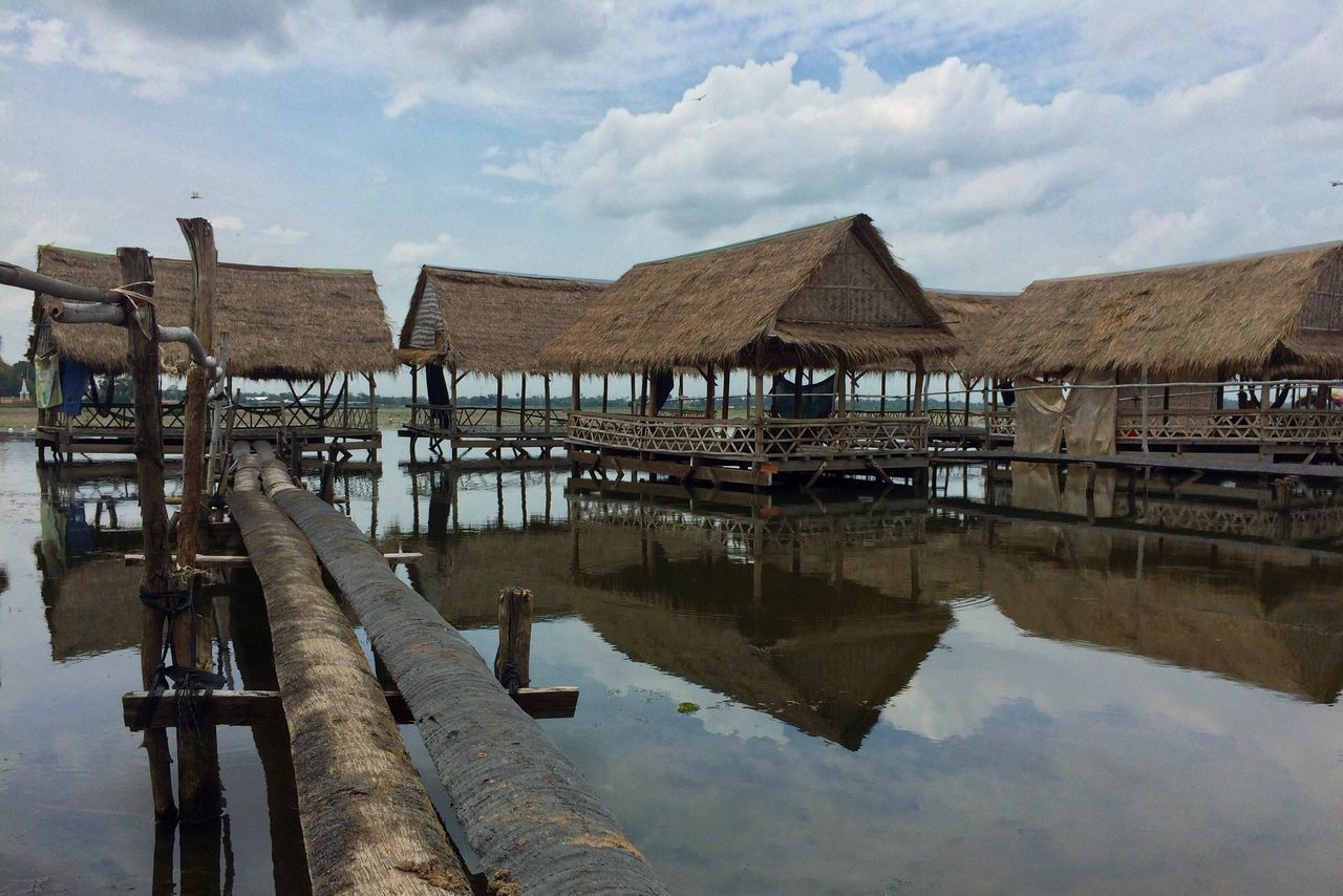 water, built structure, architecture, sky, pier, mountain, cloud - sky, tranquility, tranquil scene, wood - material, nature, scenics, cloud, jetty, beauty in nature, outdoors, day, idyllic, cloudy, no people, mountain range, wooden post, travel destinations, non-urban scene