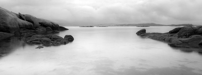 Scenic view of sea against cloudy sky