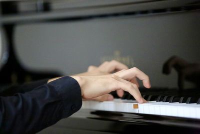 Cropped image of man playing piano