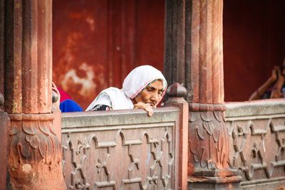 Senior woman by retaining wall at jama masjid