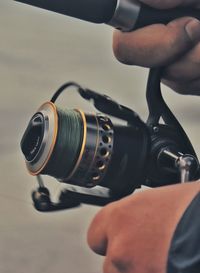 Close-up of hand holding fishing rod