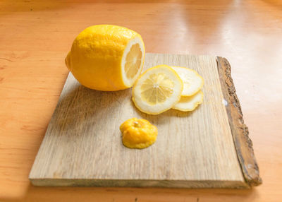 Sliced lemon slices on a wooden pallet, juicy and fresh lemon, a source of vitamins