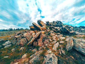 Low angle view of rock formation against sky