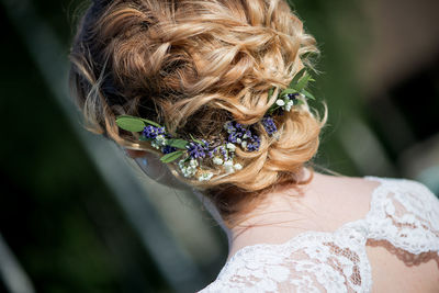 Close-up of bride wearing flowers during wedding