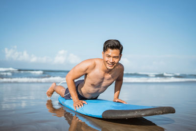 Portrait of shirtless man swimming in sea