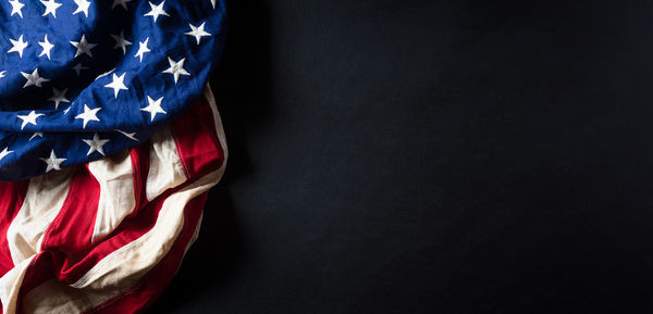 Low angle view of flag against black background