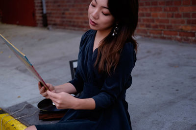 Woman sitting on wall