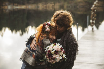 Lesbian couple embracing on jetty