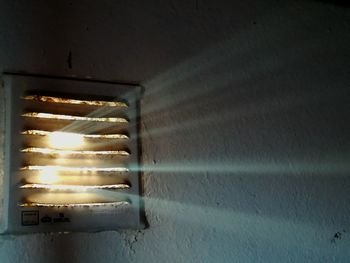 Close-up of illuminated lamp on wall